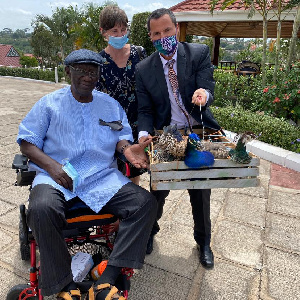 Gregory Andrews with former president, John Kufuor, and the peacock gifts