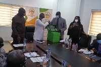 Dr Kokofu (in white) EPA boss exchanges documents with leader of the Gambian delegation