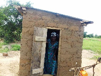 Madam Georgina Kyeremaalo pictured standing by the latrine