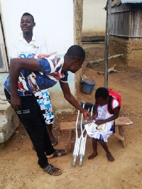 Little Ekua receiving the items donated to her