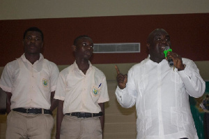 Chief of Staff, Julius Debrah with the two students