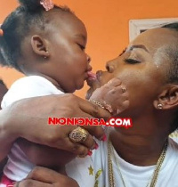 Nana Ama Mcbrown dipping her tongue in baby Maxin's mouth