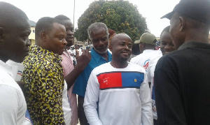 Presidential staffer, Alex Martey (in white long sleeve shirt with red and blue design)