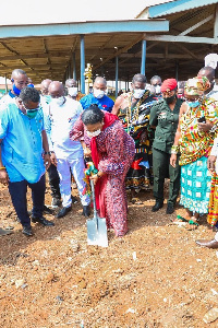 The first lady cutting sod for the construction of a 40-stall market complex at Ningo