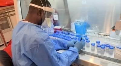 A lab technician working on COVID-19 test samples