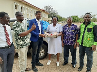 Evangelist Kingsley Makelby (L) presenting the sample of the items to Madam Mary Kalim (R)