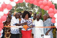 Queenstar Sawyer (M) cutting the tape for the newly built community center at Agona East