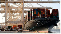 A  container ship is docked at the port of Jebel Ali