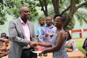 The MP handing over a bursury to one of the beneficiaries