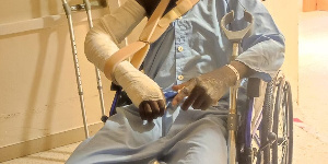 Yusif Adams in a wheelchair at the hospital