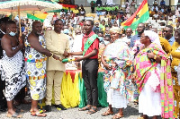 The MCE (left) hands a reward to a student at the district's 65th independence day parade