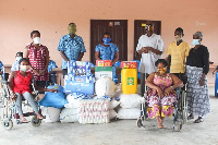 The GK and KN together with some of the cured lepers receiving the donation