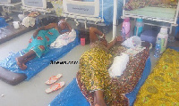 Some women lying on the floor at a hospital due to lack of beds