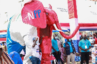 Supporters of the NPP with a giant statue of the party's emblem