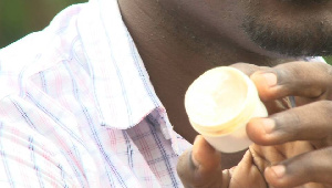 Man displays a bleaching cream | File photo