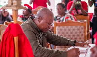 Mahama singing the book of condolences