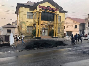 Burnt tyres in front of the Menzgold building in Kumasi