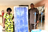 Honorable Elijah Adansi-Bonah presenting items to the health centre