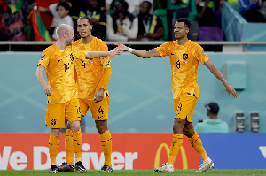 Cody Gakpo in No. 8 shirt congratulated by teammates after his goal