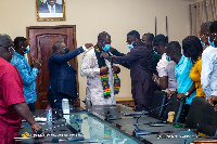 Dr. Matthew Opoku-Prempeh being decorated with a sash