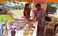 A participant examining items at the Trade Fair