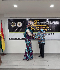 Otabil receiving his award from the Deputy Minister of Information