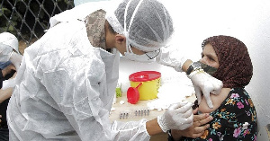 A soldier administrates the Covid-19 vaccine to a woman in Kesra