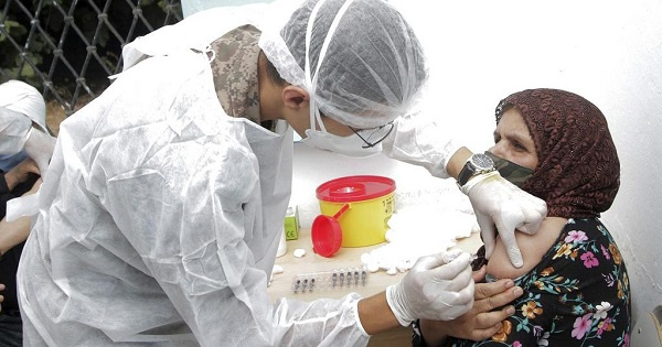 A soldier administrates the Covid-19 vaccine to a woman in Kesra