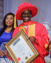 Osomafo Yaw Sarpong holding his award