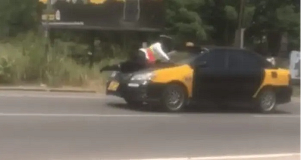 An officer lying on a vehicle bonnet for safety