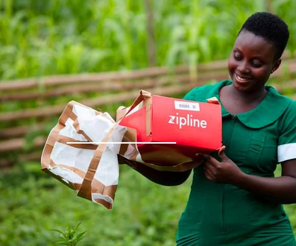 A nurse receives a zipline drone delivery