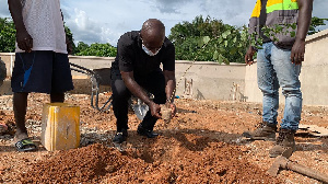 Former Ambassador to China, H.E Edward Boateng, planting a tree