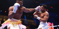 Francis Ngannou punches Anthony Joshua during their Heavyweight fight