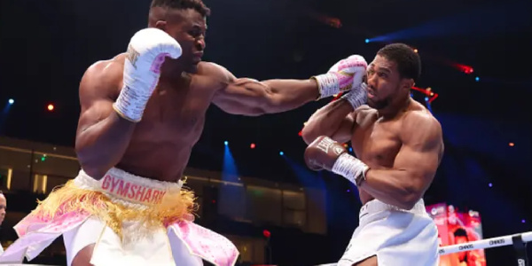 Francis Ngannou punches Anthony Joshua during their Heavyweight fight