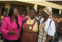 The MP and the Head of EMIS in an affectionate pose with Janet Pokua