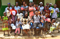 Management of the orphanage in a group photo with some of the children