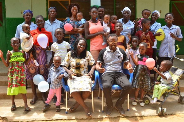 Management of the orphanage in a group photo with some of the children