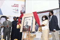 Madam Faustina Acheampong, widow and former First Lady is assisted by dignitaries to unveil the book