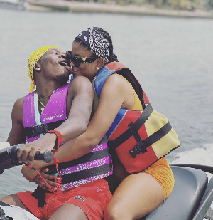 Shatta Wale kisses girlfriend on a jet ski