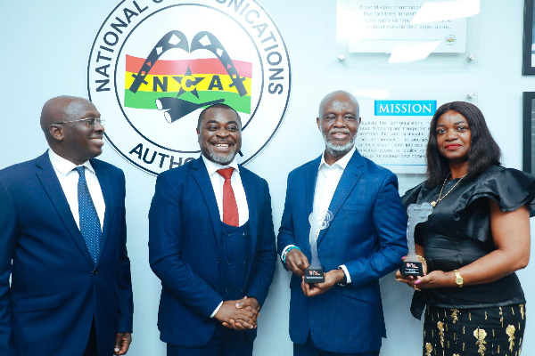 Mr. Joe Anokye  with his two deputies, receiving the prestigious award in Accra from  Mr. Akin