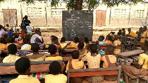 Basic pupils studying under a tree