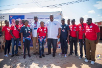 Some members of the Patriotic Professionals in a photo with some residents