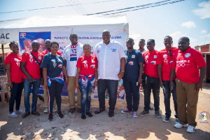 Some members of the Patriotic Professionals in a photo with some residents