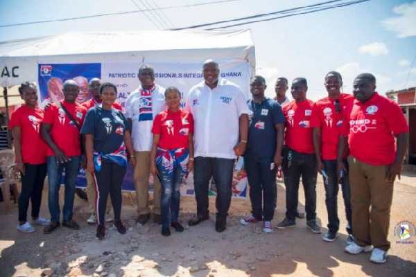 Some members of the Patriotic Professionals in a photo with some residents