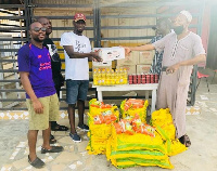 Former Campaign Director of  Charles Amoako Brobbey presenting items to the vulnerable