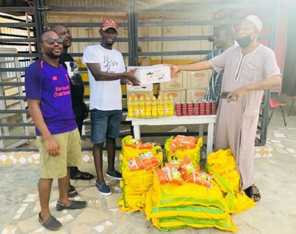 Former Campaign Director of  Charles Amoako Brobbey presenting items to the vulnerable