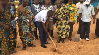 Alex Incoom cutting the sod for work to commence