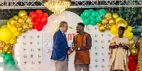 Ghanaian football leged, Asamoah Gyan picking up his award