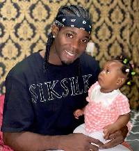 Lawrence Ati Zigi with a baby