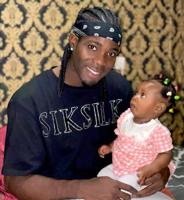 Lawrence Ati Zigi with a baby